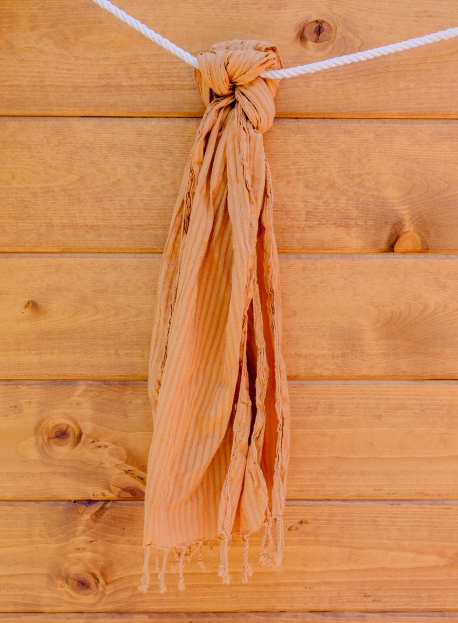 scarf tied into a knot against a wooden background