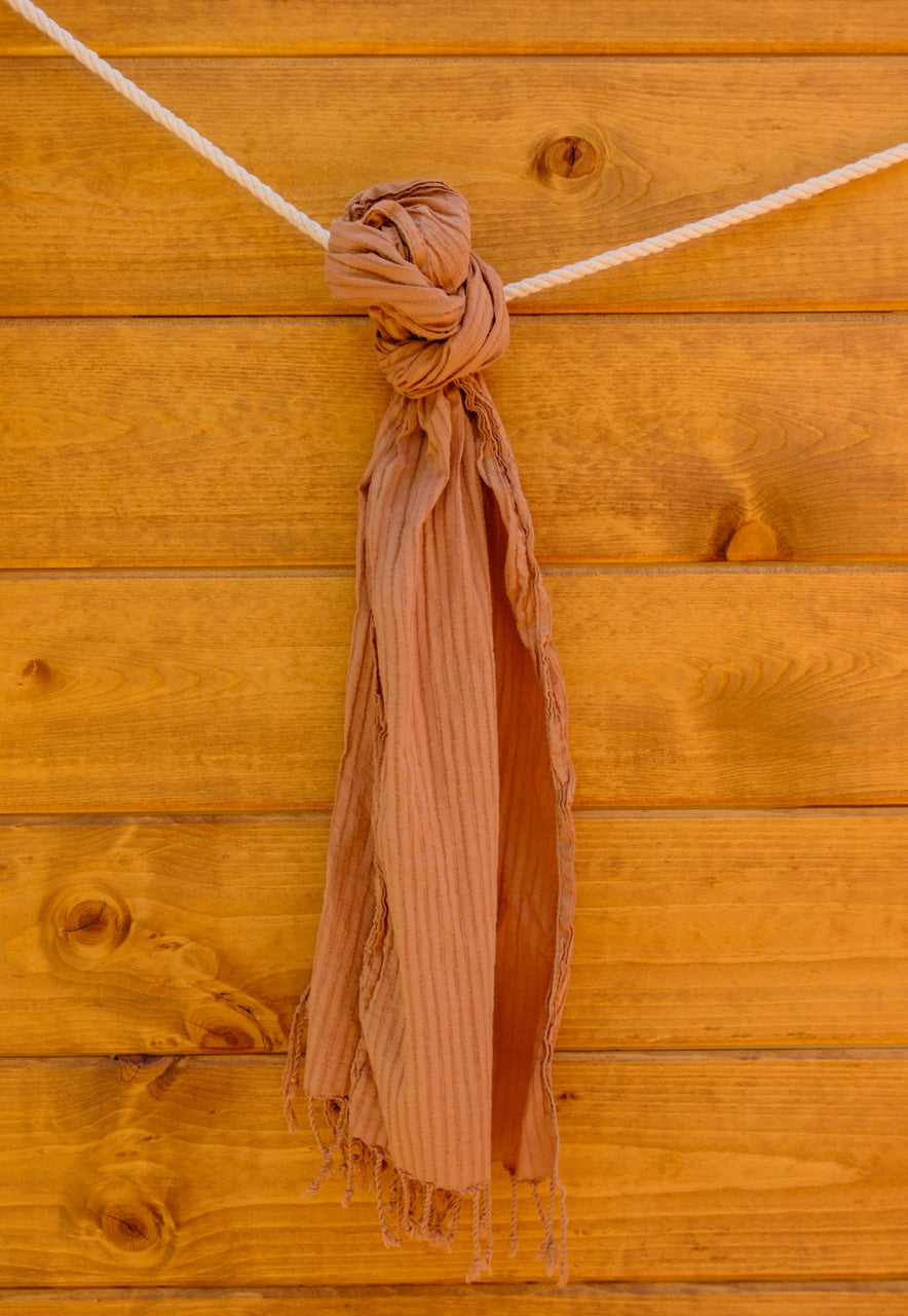 scarf tied to a wooden surface