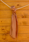 scarf tied to a wooden surface