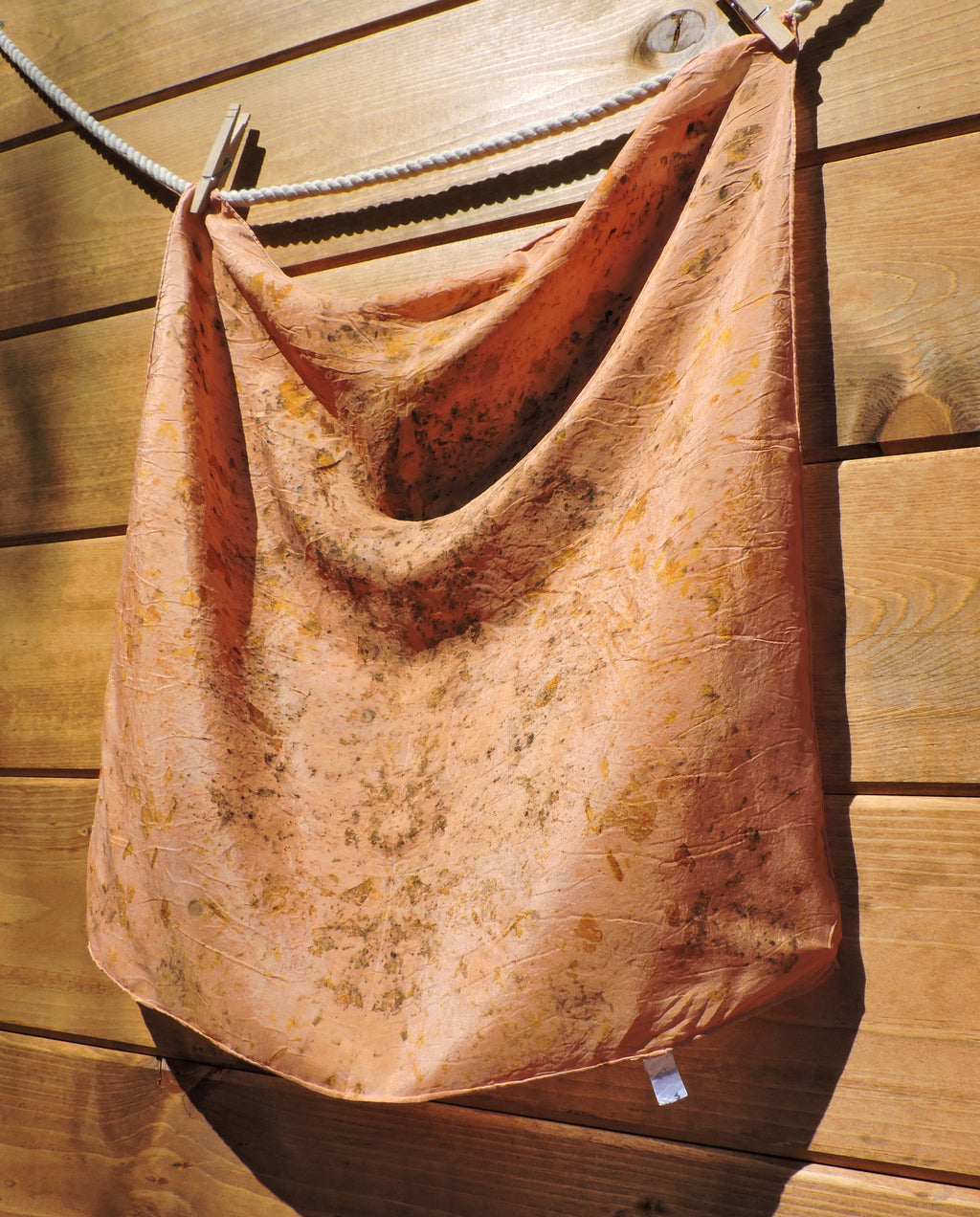 silk scarf hanging on a wooden surface