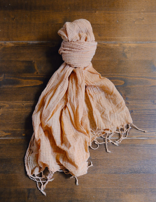 orange scarf on a wooden surface