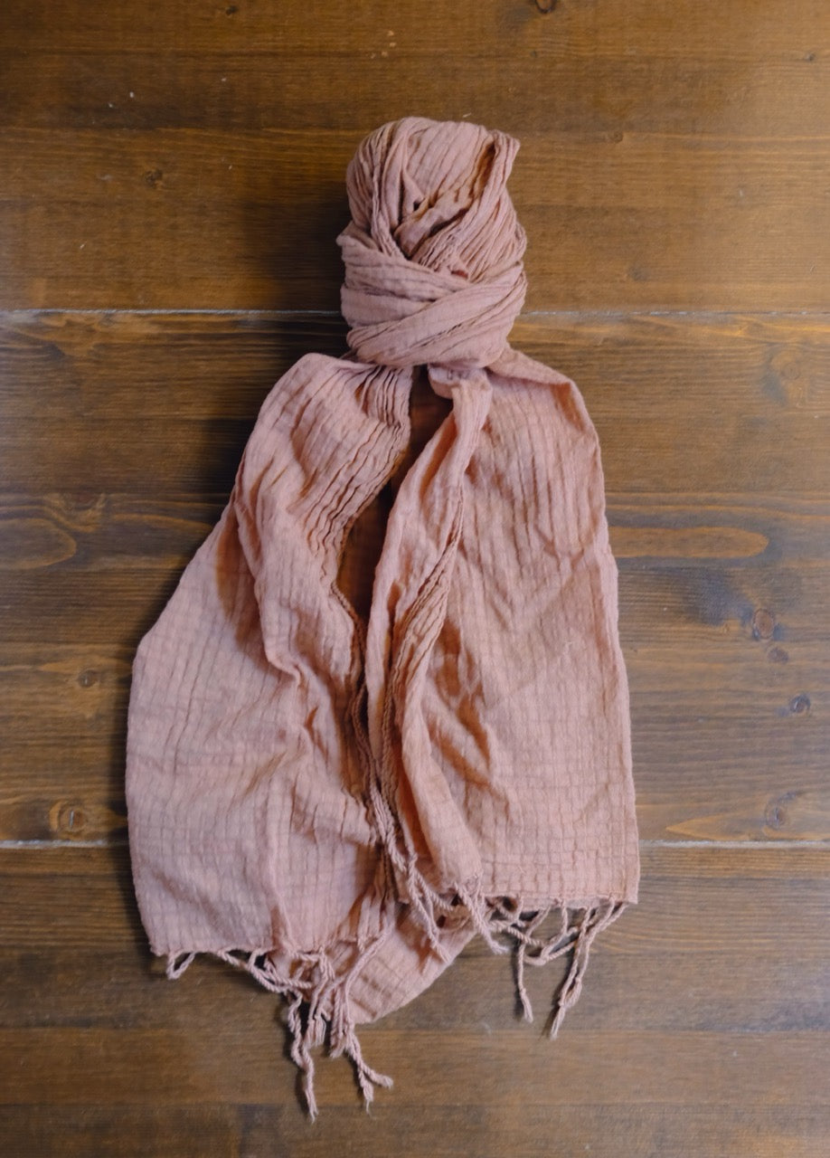 brown scarf on a wooden surface