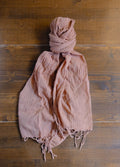 brown scarf on a wooden surface