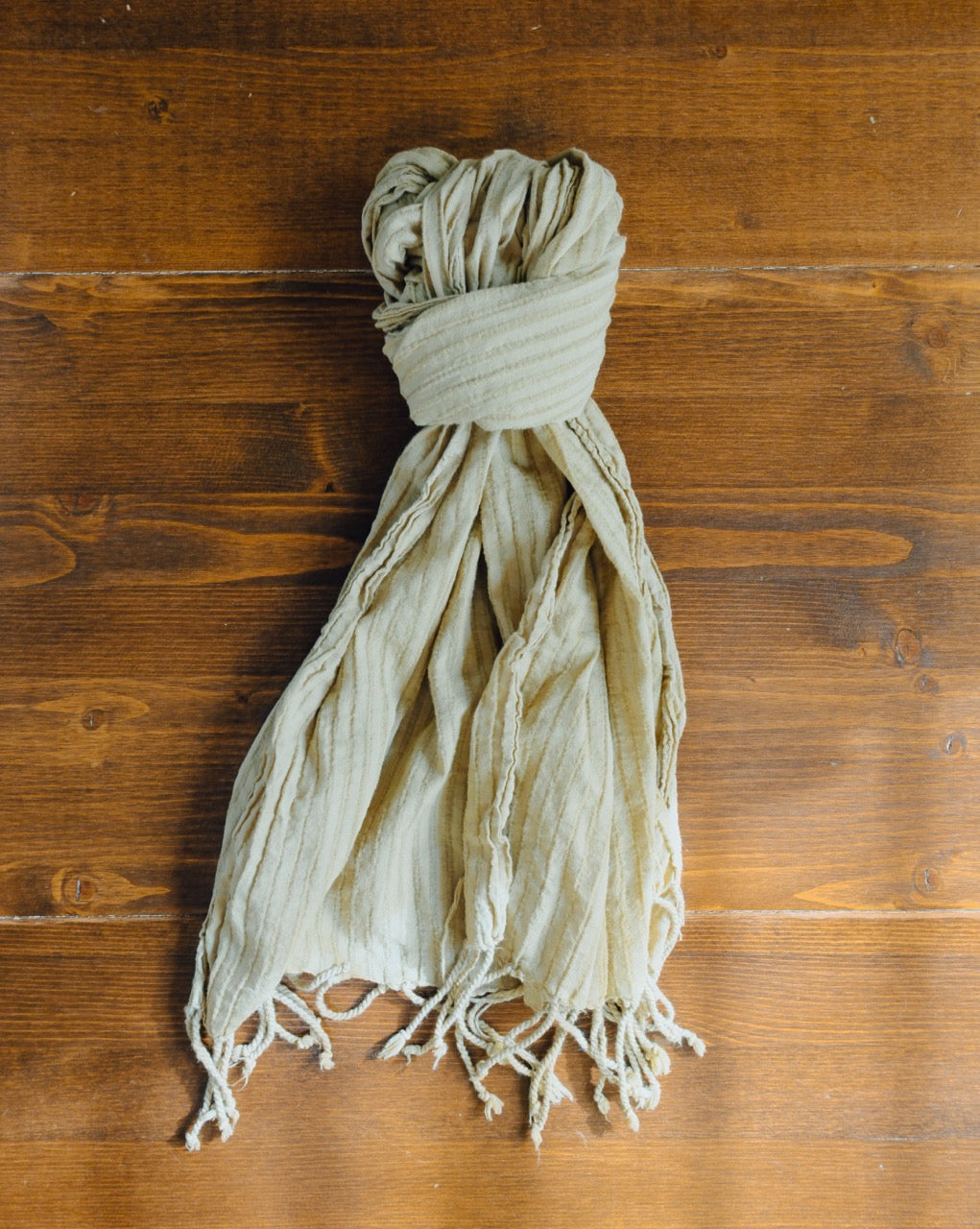 scarf tied in a knot on a wooden surface