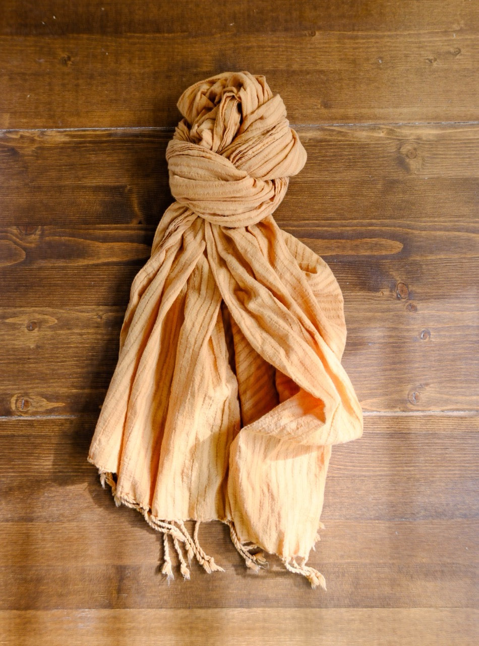 scarf tied in a knot on a wooden surface