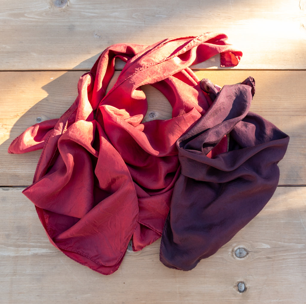 three silk bandanas, two cherry red and one a purple burgandy shade